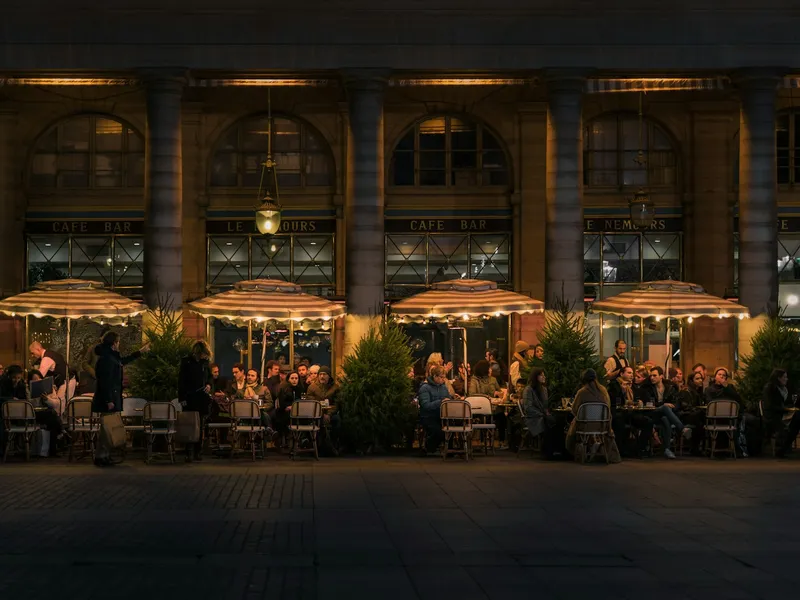 Restaurant patio with outdoor dining tables lit for evening service